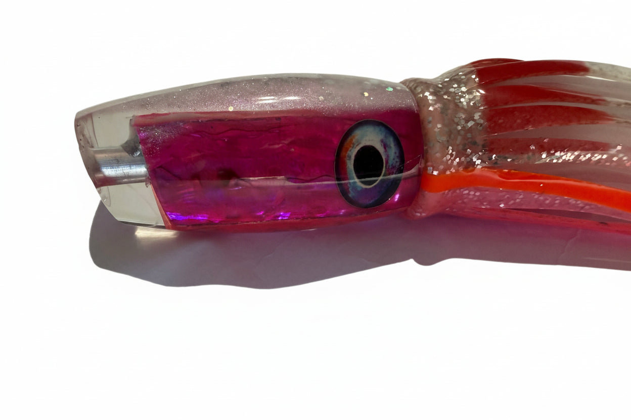 Close-up of a pink offshore trolling lure with abalone resin head and fish eye design