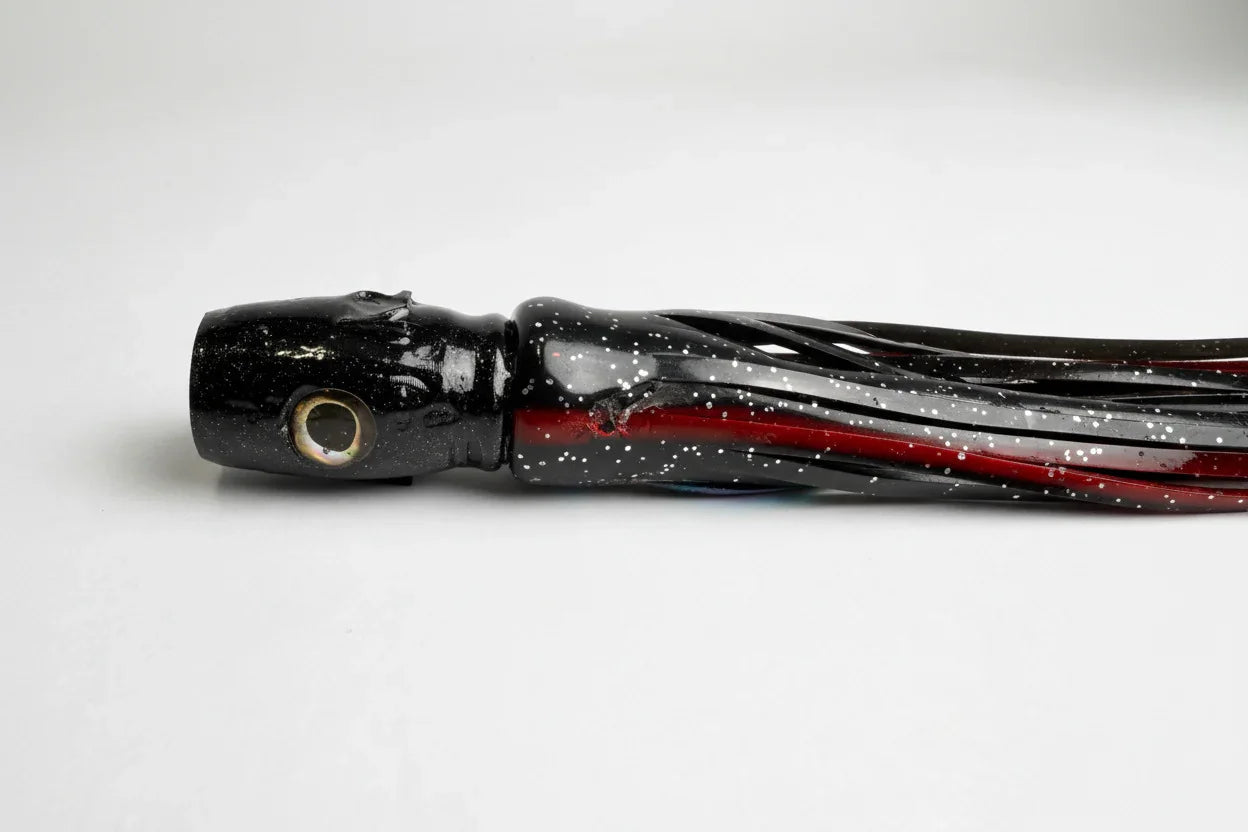 Black and red offshore trolling lure with abalone resin finish and speckled pattern