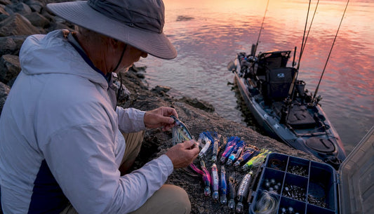 Angler sorting offshore trolling fishing lures on dock