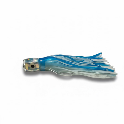 A blue and white plastic fishing lure with a clear head and a realistic eye, lying on a light beige fabric surface.
