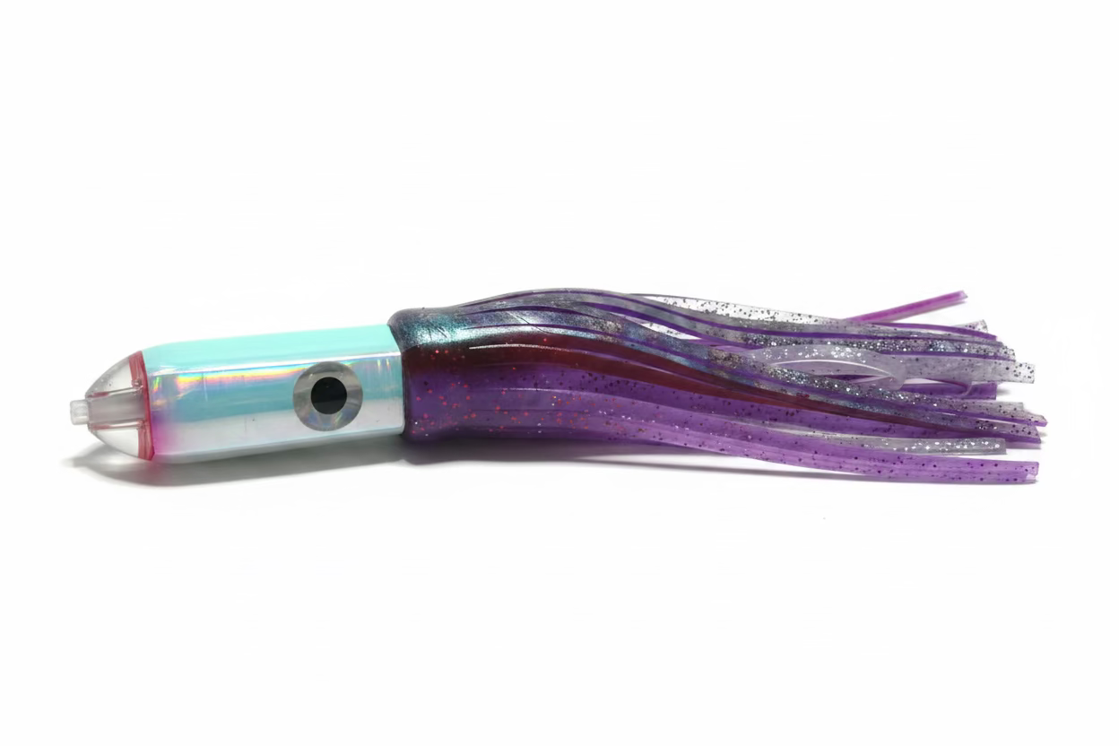 A plastic fishing lure with a light blue and white striped head, a red accent ring, and a translucent purple skirt with glitter, resting on a beige fabric surface.