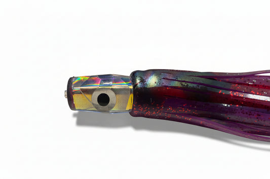 Close-up of the Tracker resin trolling lure's faceted holographic Big Eye head and dark Purple double skirt