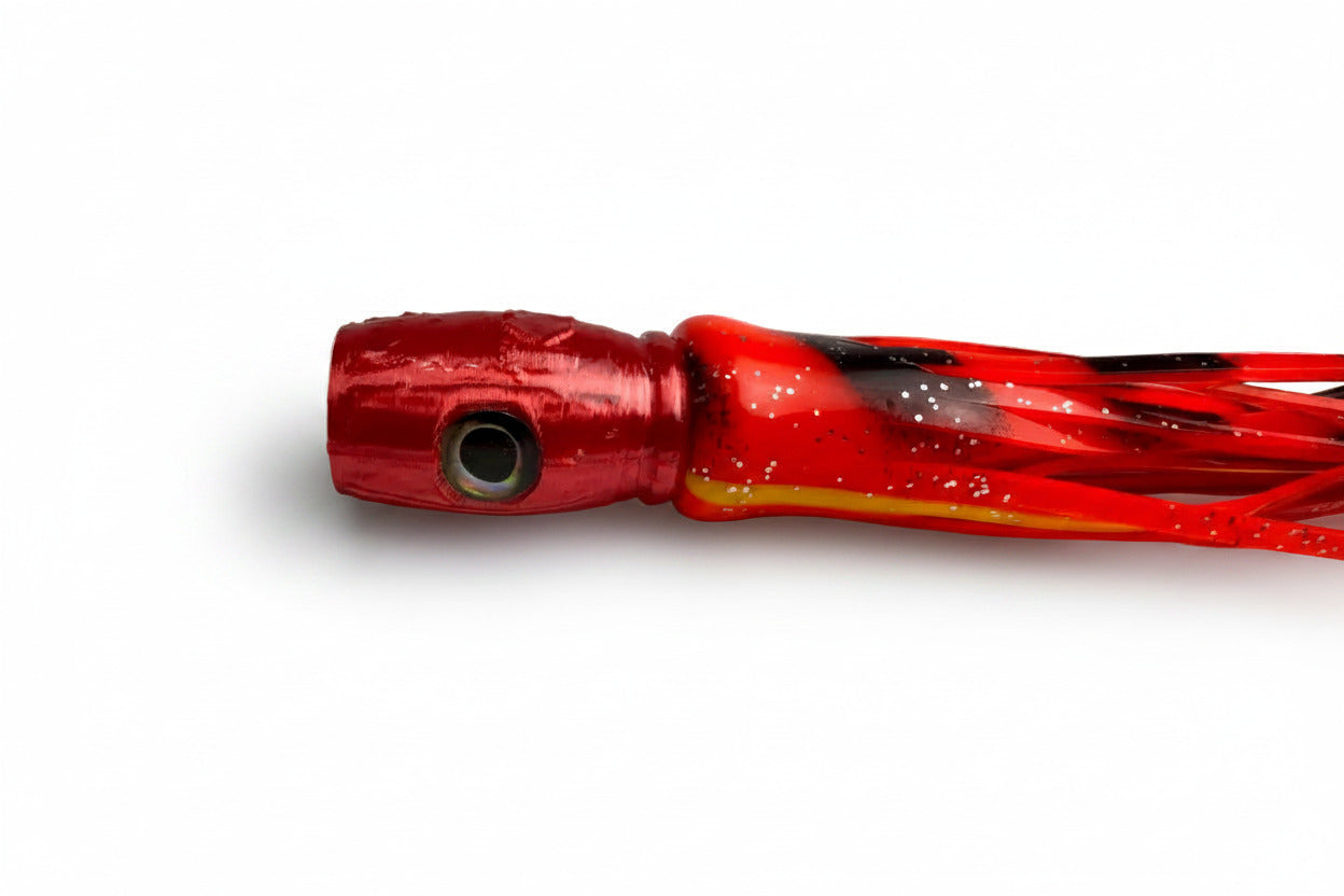 Red abalone resin offshore trolling lure with reflective eye on white background