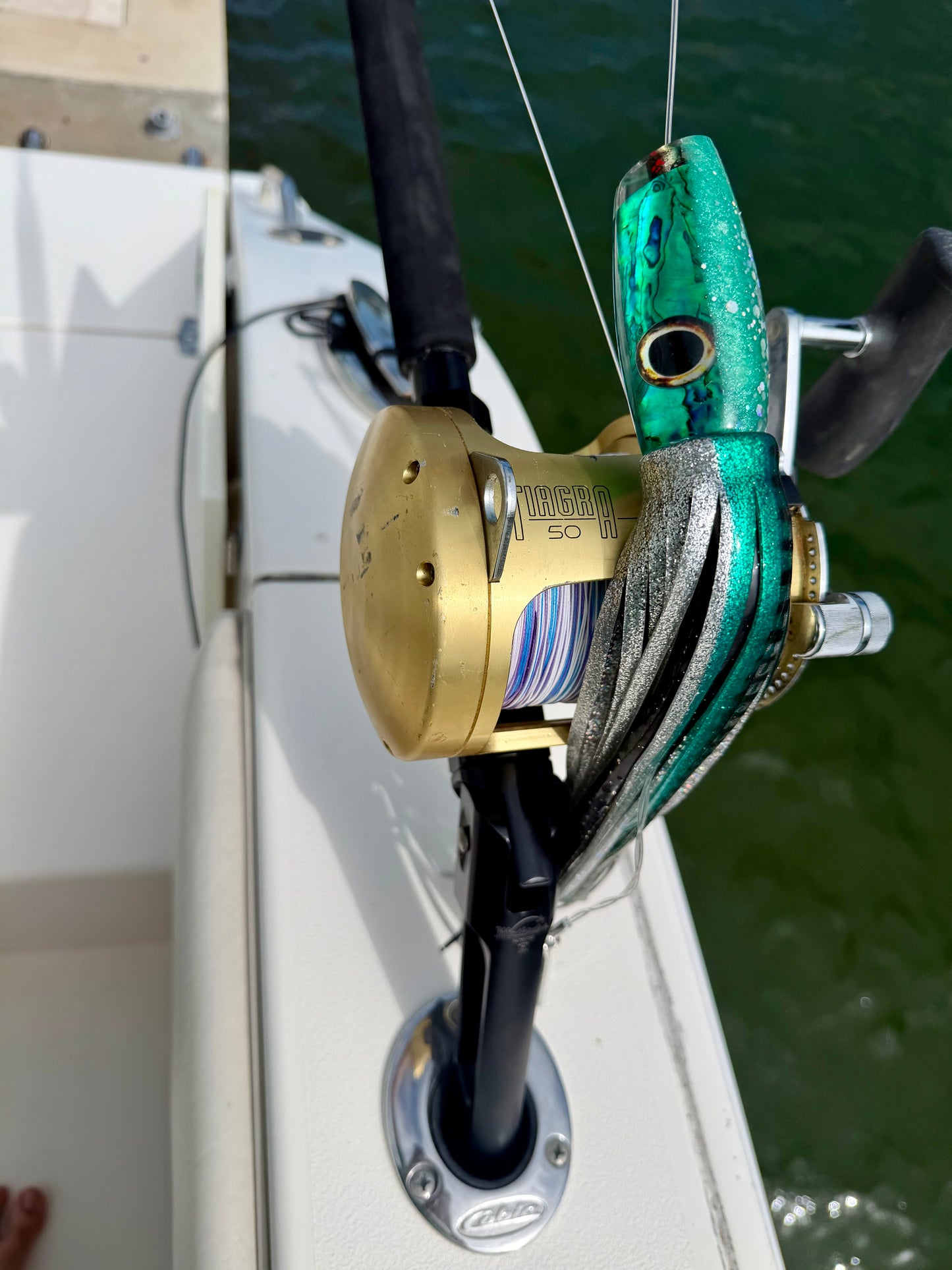 Green lure with a deep sea fishing rod for tolling for big game fish.